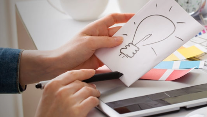 hands of woman near computer with art
